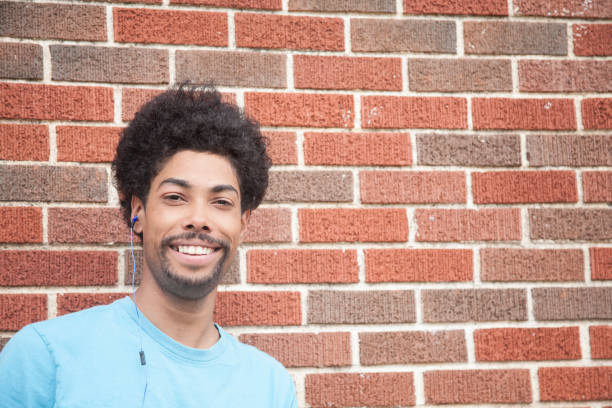 istock Latin descent, young adult man with earbuds. 683734268