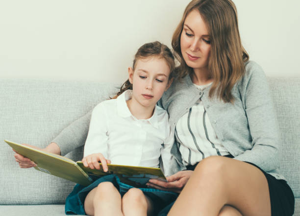 istock Mother and daughter reading a book. 683739972