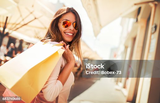 istock Shopping time. Young woman in shopping looking for presents. Consumerism, shopping, lifestyle concept 683740686