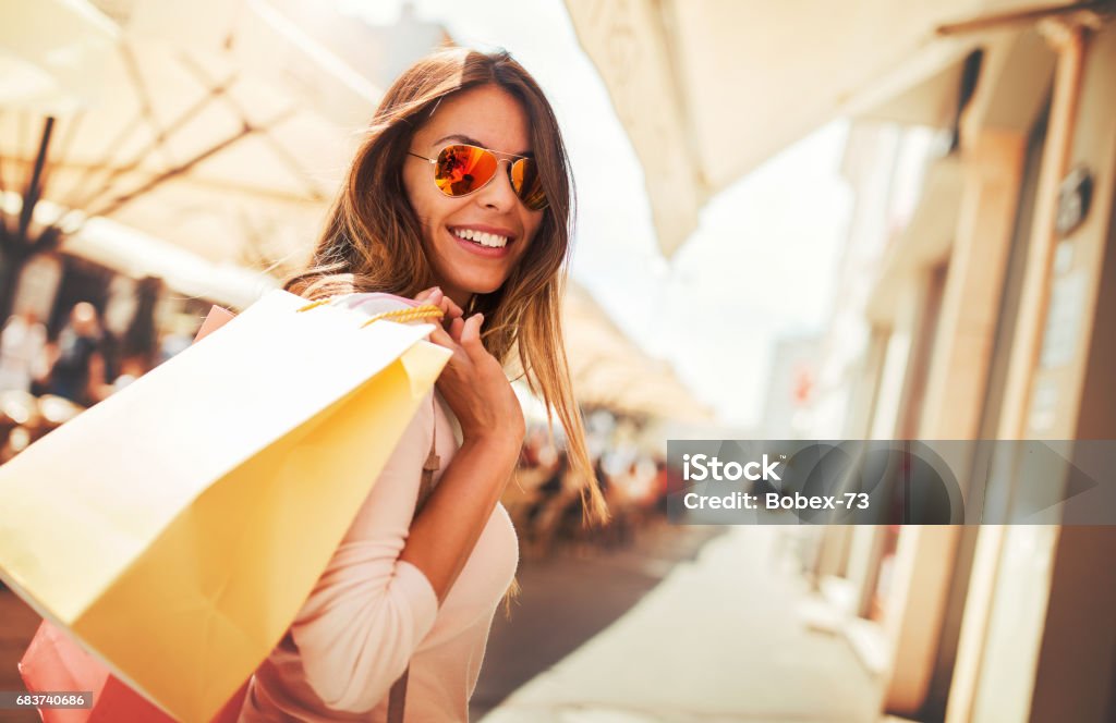 Shopping time. Young woman in shopping looking for presents. Consumerism, shopping, lifestyle concept Woman in shopping. Happy woman with shopping bags enjoying in shopping. Consumerism, shopping, lifestyle concept Retail Stock Photo