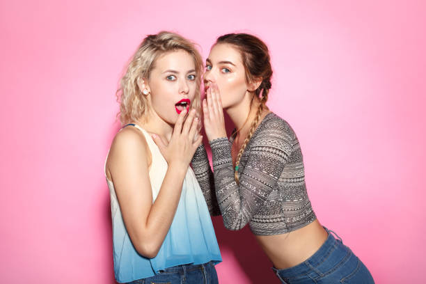 istock Two young girl gossiping 683746528
