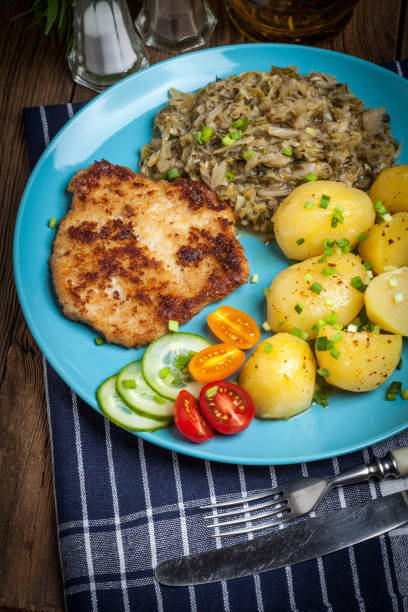 istock Fried pork chop, baked potatoes and fried young cabbage. 683747492