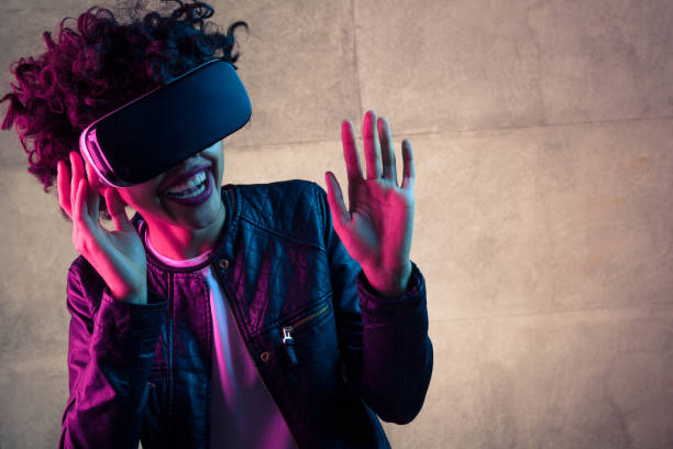 istock Laughing woman with VR goggles 683747570