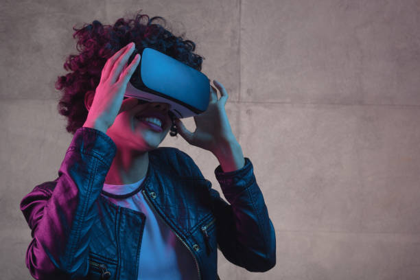 istock Young girl touching VR helmet 683747616