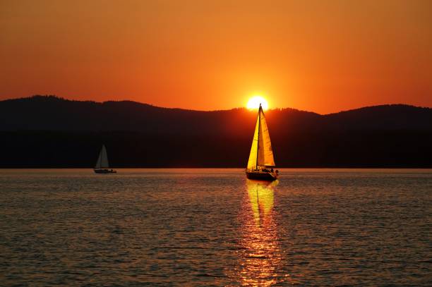 istock Sailboat sail off into the sunset on Lake. 683748216