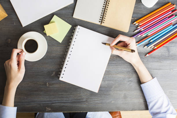 istock Woman writing in spiral notepad 683751110