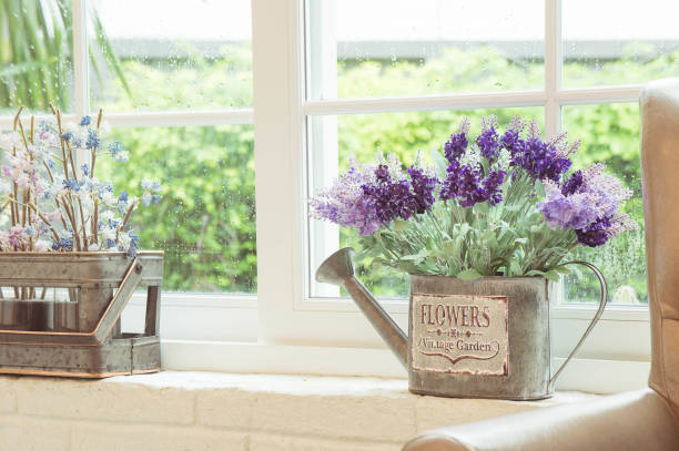 Roses, tulips in a vase with a watering can and a red heart