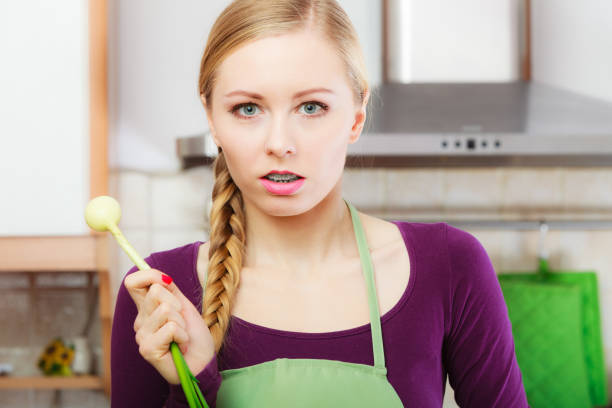 istock Woman in kitchen holds green fresh chive 683763322