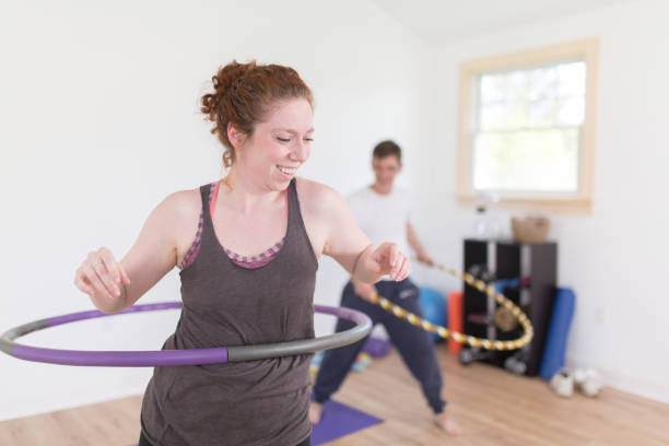 Hooping Class Hooping Fitness instructor weighted hula hooping stock pictures, royalty-free photos & images