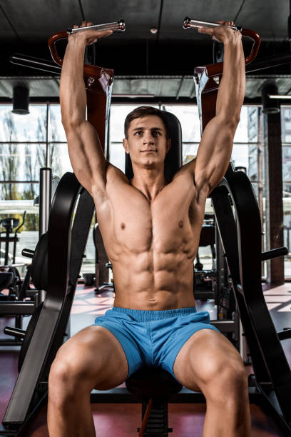 istock Tense muscles of hands under load. Man doing exercise for biceps in the gym 683770074