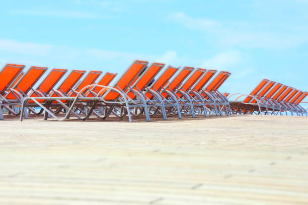 row of sun loungers on the beach