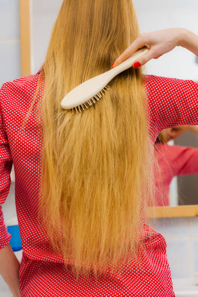 istock Woman brushing her long hair in bathroom 683777250