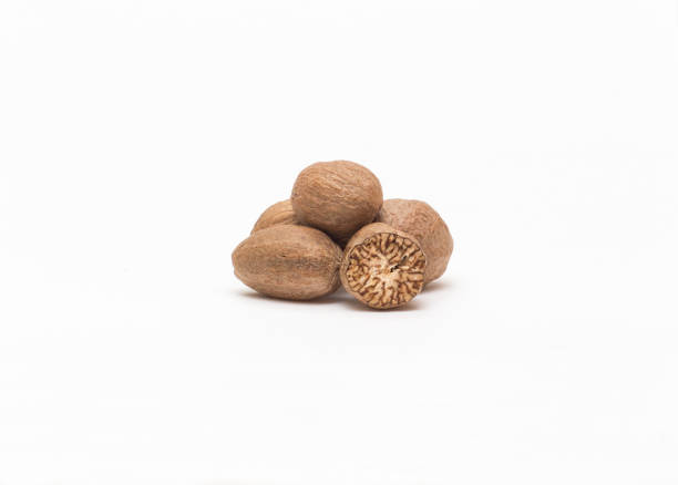 Nutmeg on a white background close-up nutmeg isolated on white background with shadow nutmeg stock pictures, royalty-free photos & images