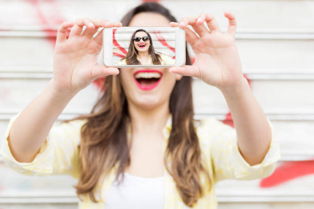 istock Smiling woman taking a selfie 683787572