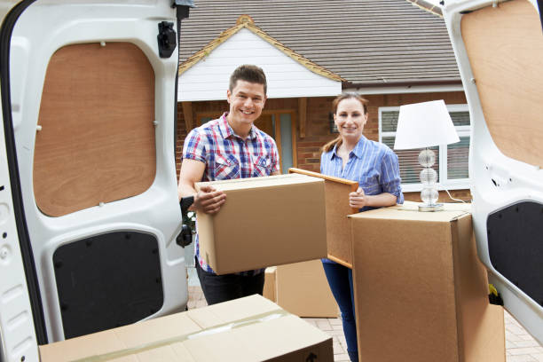 istock Young Couple Moving In To New Home  Unloading Removal Van 683789104