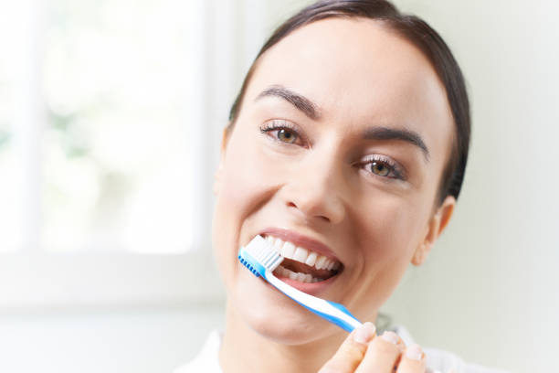 istock Woman Brushing Teeth With Toothbrush In Bathroom 683789948