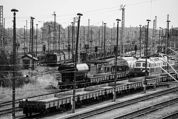 Railway in station with blurred man and woman standing between the railway