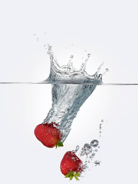 strawberries diving into water - wet strawberry macro fruit imagens e fotografias de stock