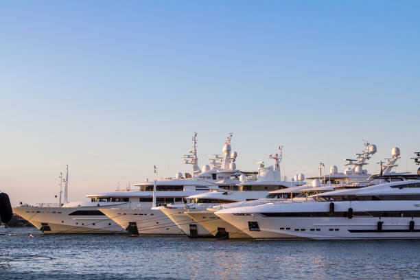 Luxury, rich Yachts moored in a harbor of Porto Cervo Luxury Yachts moored in a harbor of Porto Cervo on the early sunset, Sardinia, Italy moored photos stock pictures, royalty-free photos & images