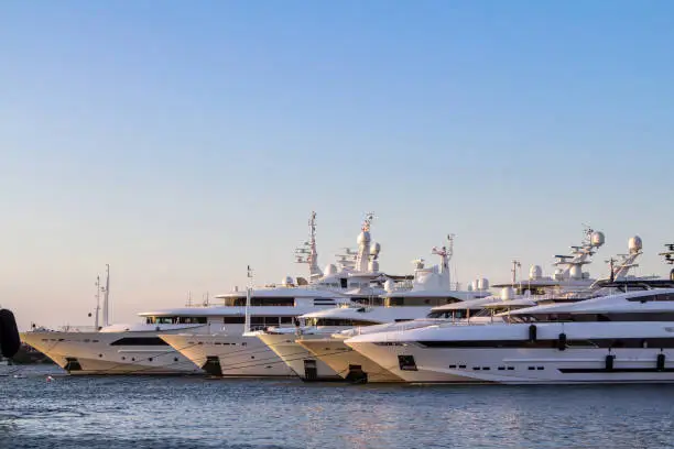 Photo of Luxury, rich Yachts moored in a harbor of Porto Cervo