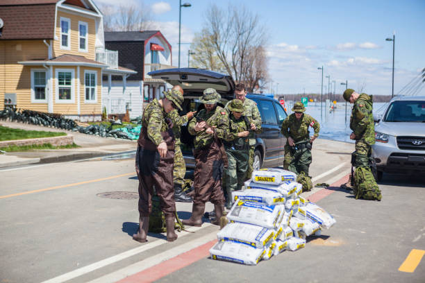 Gatineau Flooding Gatineau, Canada - May 10, 2017: This is the big flood of the city of Gatineau, Quebec, Canada. On this picture, we can see the Gatineau River flooding the rue Jacques Cartier. And on the road, there are Canadian soldiers in preparation to help people who are isolated by the floods. flood preparation stock pictures, royalty-free photos & images