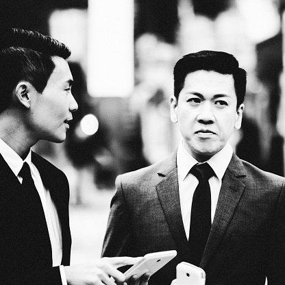 Two asian businessmen in the city of Hong Kong