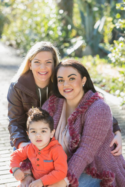 istock Little boy with two mothers  in the park 683821252