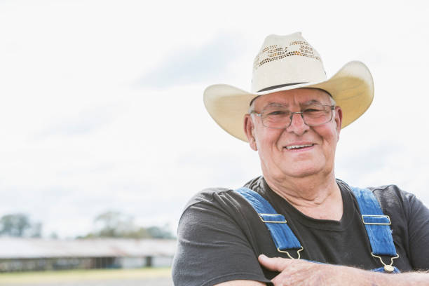 istock Farmer wearing overalls, barn in background 683827060