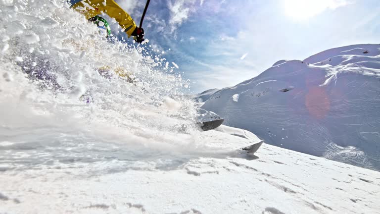 SLO MO Female skiing in powder snow splashing the camera