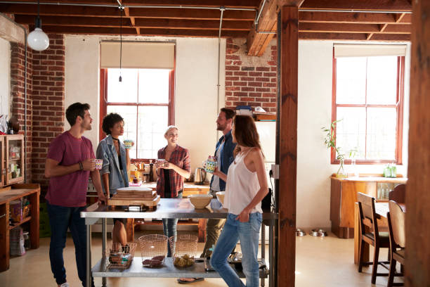 istock Friends talking over coffee in kitchen, three quarter length 683841318