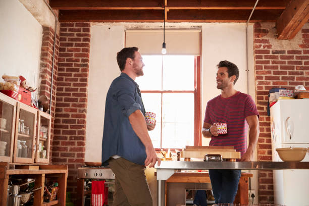 istock Two male friends hanging out in kitchen, low angle 683841424