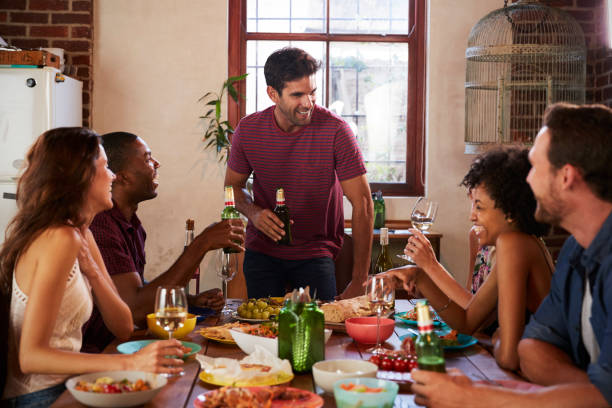 istock Friends with drinks at the table during a dinner party 683843834
