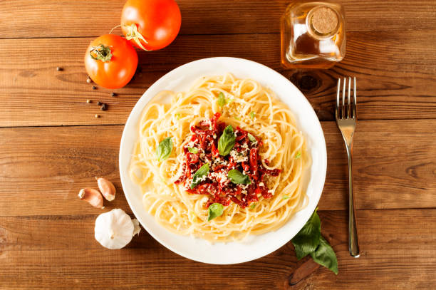 istock Italian dish - pasta with sundried tomato and basil. Top view 683844894