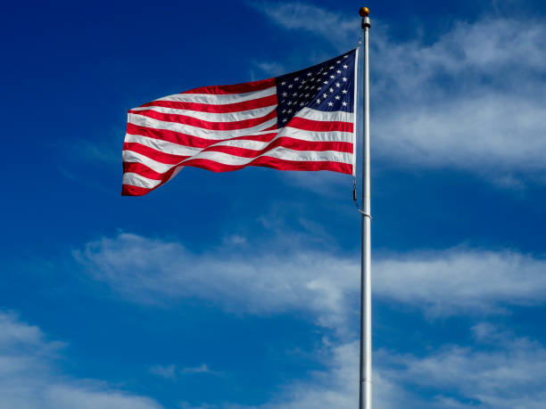 istock American Flag Against a Blue Sky 683853116