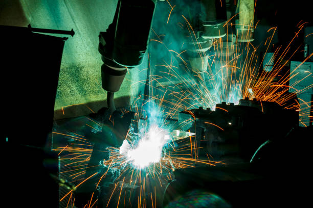istock Welder robots movement in a car factory 683870192