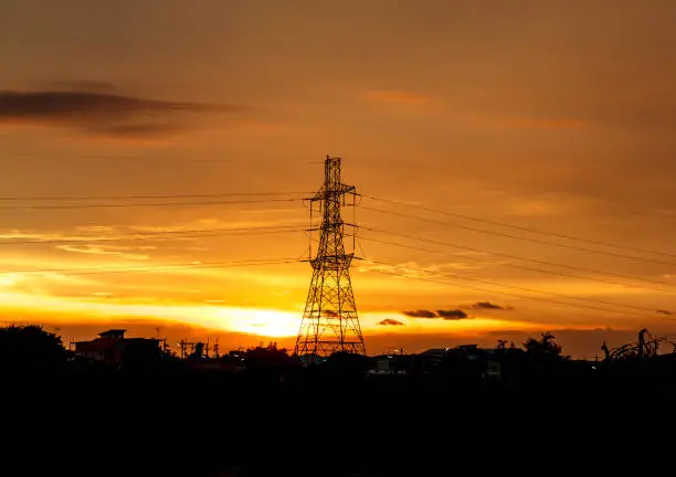High voltage pylons on the evening sunset, silhouette