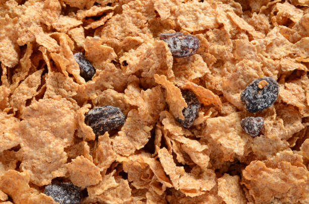 Dry Cereal Close Up An abstract image of dry bran cereal with raisins. bran stock pictures, royalty-free photos & images