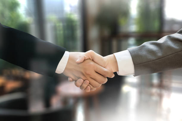 istock M&A (MERGERS AND ACQUISITIONS) , Businessman handshake working at office M&A 683884782