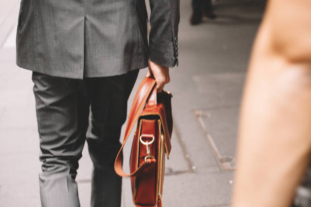 istock businessman walking through city 683884944