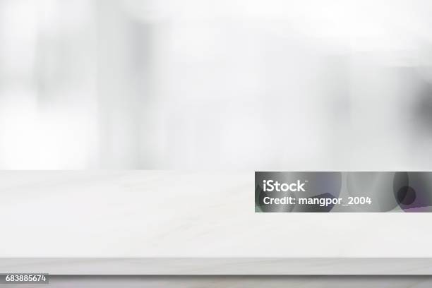 Empty White Marble Over Blur Store Background Product And Food Display Montage Stock Photo - Download Image Now