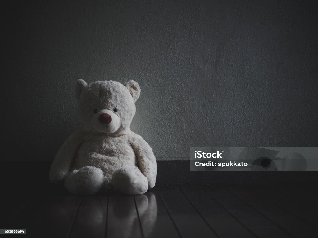 Lonely Teddy Bear Sitting In The Dark Room Stock Photo - Download Image Now  - iStock
