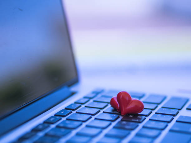 istock Red heart on the computer keyboard with sunlight and shadow. Internet dating, copyspace, Valentines day concept. 683888812