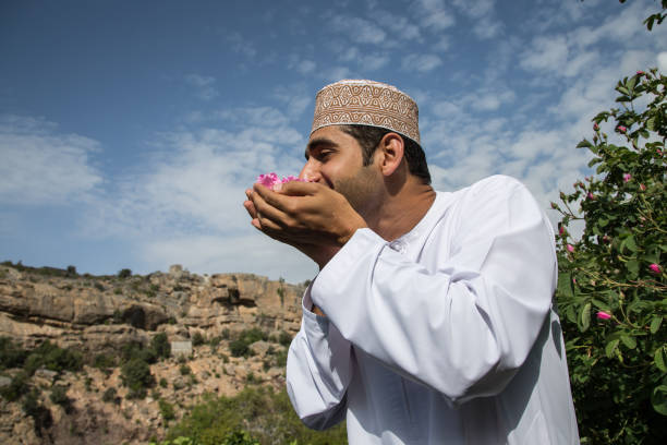 young oman man smelling rose petals - harbor imagens e fotografias de stock