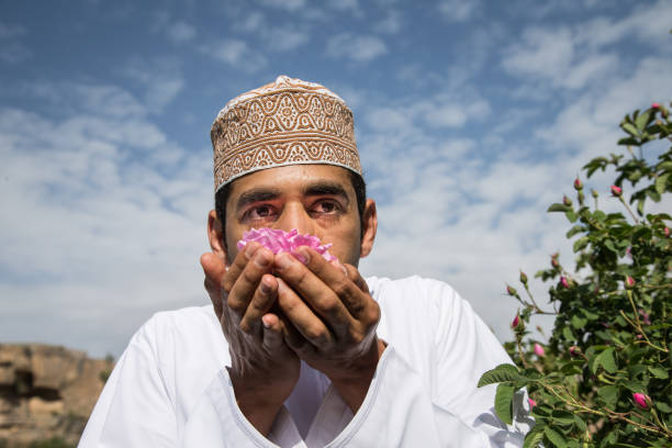 young oman man smelling rose petals - harbor imagens e fotografias de stock