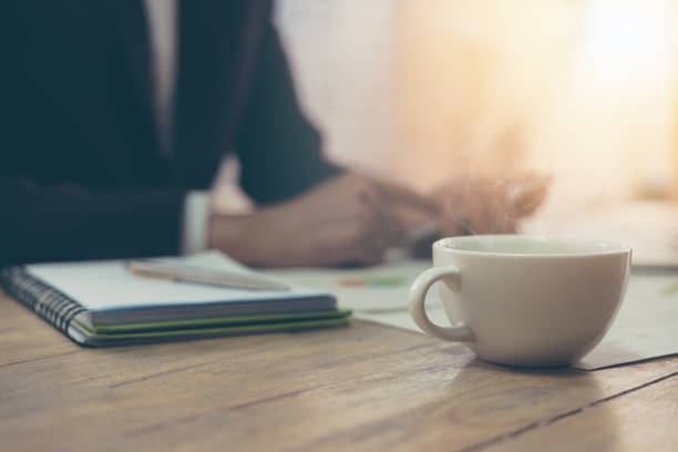 istock Business man and using laptop computer and mobile smart phone at office. selective focus at cup of hot coffee 683891502