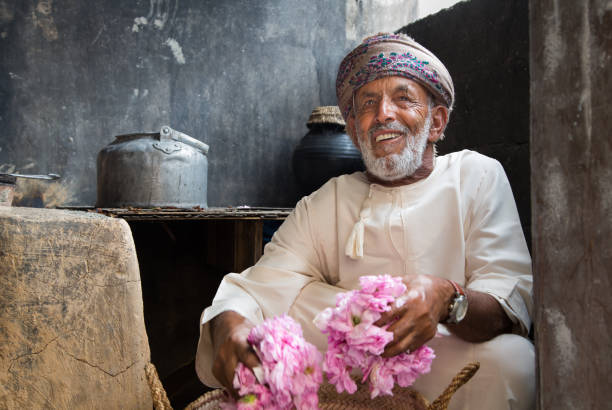 omani man with rose petals - harbor imagens e fotografias de stock