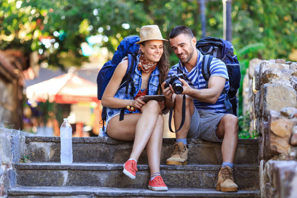 istock Tourists looking at tablet on street 683896796