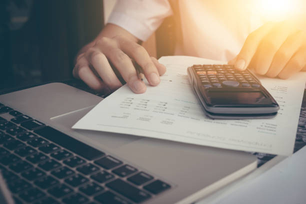 istock Businessman calculate cost and expenses using laptop for search data result. 683897450