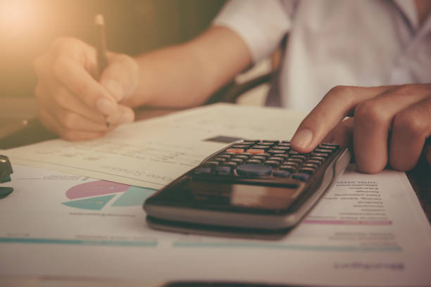 istock Businessman calculate cost and expenses using laptop for search data result. 683898196