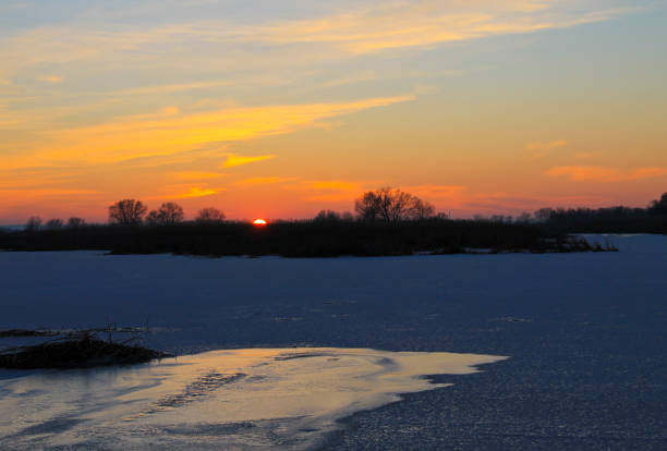 istock Sunset over a frozen river Dnieper on winter 683900630